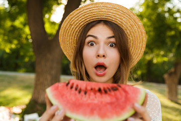 Close up of excited young girl in summer hat