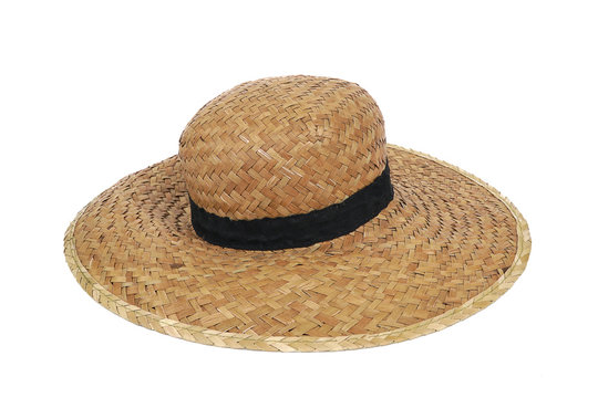 Summer beige straw hat isolated on white background.Close up of handcraft weave wide brim hat made from reed,bamboo,rattan.Decoration with ribbon band on plain design.Fashion,Holiday,Decor Concept.