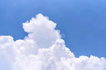White puffy cumulus cloud on blue sky as background