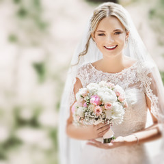 Close-up of bride holding bouquet of flowers