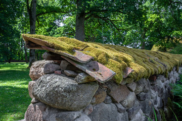 An old moss covered dry stone wall in forest