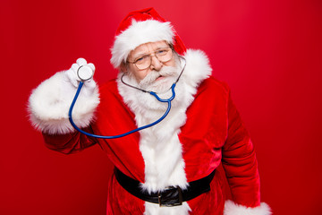 Worried calm Santa look at camera hold stethoscope in hand stand