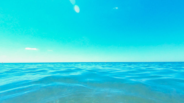 Fototapeta Smooth surface of the sea in summer on a Sunny clear day