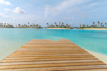 Amazing island in the Maldives ,Beautiful turquoise waters ,wooden bridge with  blue sky  background for holiday vacation .