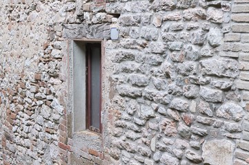 Isolated window in a stone wall (Marche, Italy, Europe)