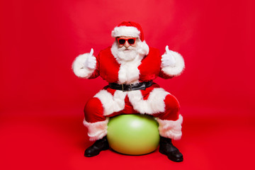 Funny cheerful positive stylish Santa in eyeglasses white fluffy