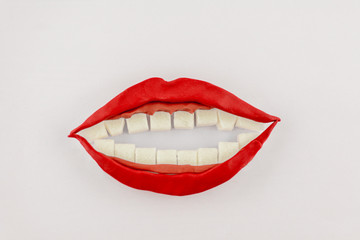 sweet smiling mouth, model from clay Lips and gums were cut from colored clay, teeth of cubes of refined sugar