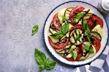 Italian salad caprese with eggplants and balsamic vinegar.Top view with copy space.