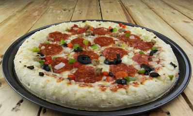 Delicious pepperoni pizza on wooden table.