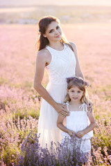 Happy family in a field of lavender on sunset.