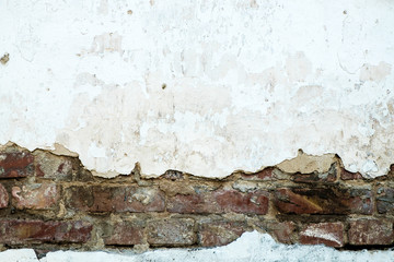 Naklejka na ściany i meble Damaged brick wall, cracked plaster. Textured background