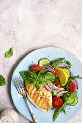 Grilled chicken breast with vegetable salad.Top view with copy space.