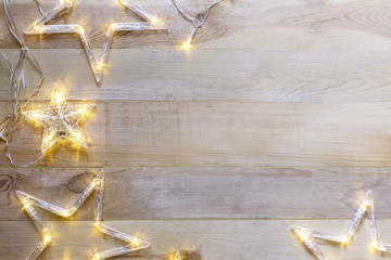 Wooden  Christmas background with star shaped lights.