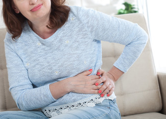 Middle aged woman with backache at home