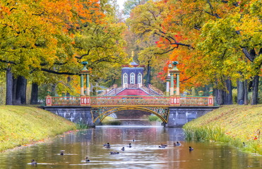 Cross bridge and Chinese bridge in golden fall in Alexander park, Pushkin, St. Petersburg, Russia