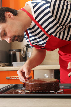 A man is cooking classical Cake