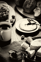 Breakfast in French, in European. Camembert cheese, jam, coffee, olives, fresh pastries and pistachio nuts