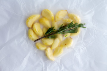 Rosemary infused fresh whole garlic cloves in a bag