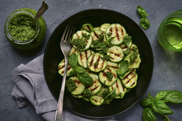 Grilled zucchini slices with pesto sauce.Top view.