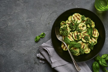 Grilled zucchini slices with pesto sauce.Top view.