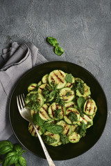 Grilled zucchini slices with pesto sauce.Top view.