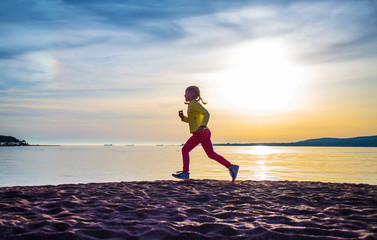  girl running along  sea beach
