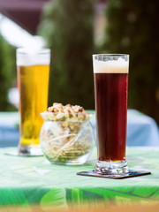 light and dark beer with snacks on the table on the bar terrace outdoor