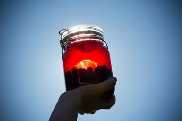 Sloe berries and gin combined in a glass jar prior to being put down to infuse and form sloe gin