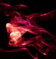 Red smoke on black background