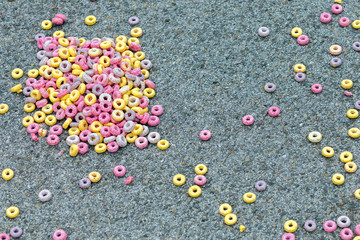 colored, corn Breakfast cereals scattered on the pavement, the road