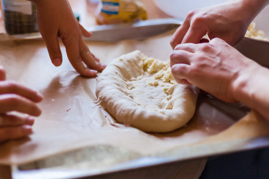 Two girls make dough and cheese from Georgian national pastries, hands