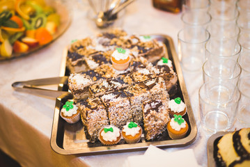 Delicious sweets on wedding candy buffet with desserts, cupcakes