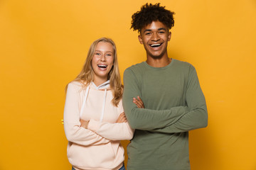 Photo of happy students man and woman 16-18 with dental braces laughing at camera, isolated over...