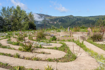 Maze concrete pathway of a labyrinth on the edge of misty valley in Hogsback, South Africa
