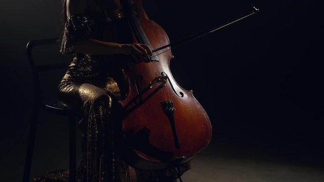 The cellist performs on stage.