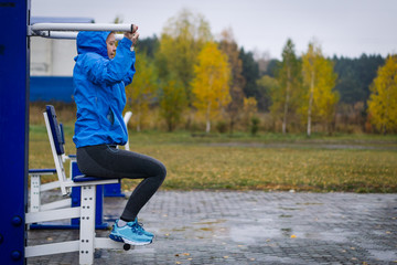 Fitness Woman Using  Exercise Machines outdoor.Fit and healthy.