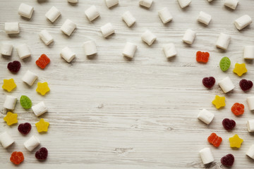 Candy on a white wooden background, top view. From above, flat lay, overhead. Copy space.
