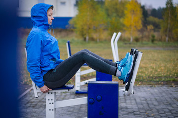 Fitness Woman Using  Exercise Machines outdoor.Fit and healthy.