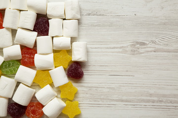 Candy on a white wooden surface, top view. From above, flat lay, overhead. Copy space and text area.