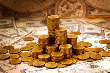 Capitalism concept : Coin stack on bank note and vintage map background.