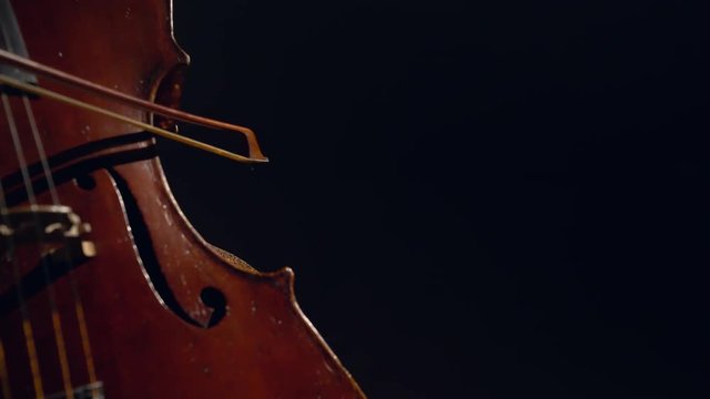 The cellist performs on stage.