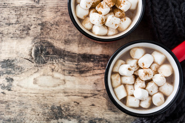 Christmas cocoa with marshmallow in mug on wooden table. Top view. Copyspace