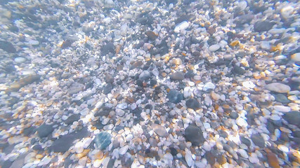 Photo underwater bottom of the Black sea with stones and pebbles in summer