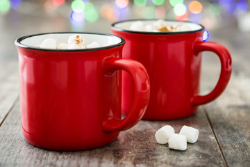 Christmas cocoa with marshmallow in mug on wooden table. Copyspace