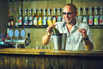Emotional bartender spills champagne behind the bar