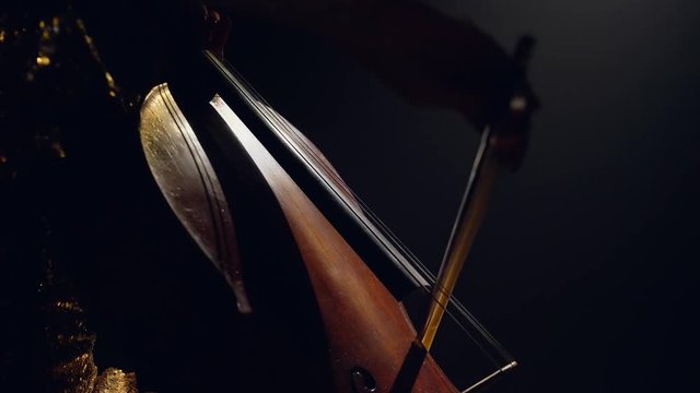 The cellist performs on stage.