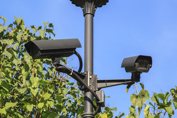 outdoor video surveillance cameras (cctv) installed in several directions for easy monitoring of the order in the modern city Park