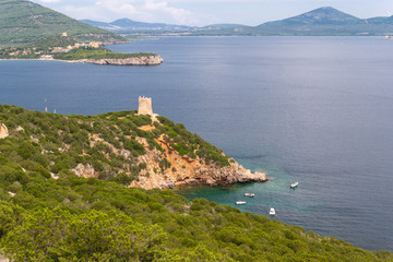 Fototapeta na wymiar Seascape of Capo Caccia with sighting tower and boat, Sardinia, Italy.