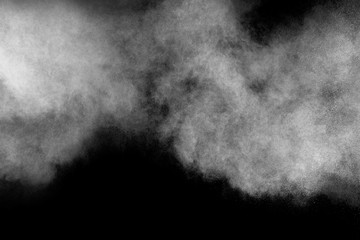 Bizarre forms of white powder explosion cloud against black background.