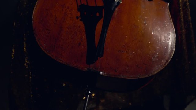 The cellist performs on stage.